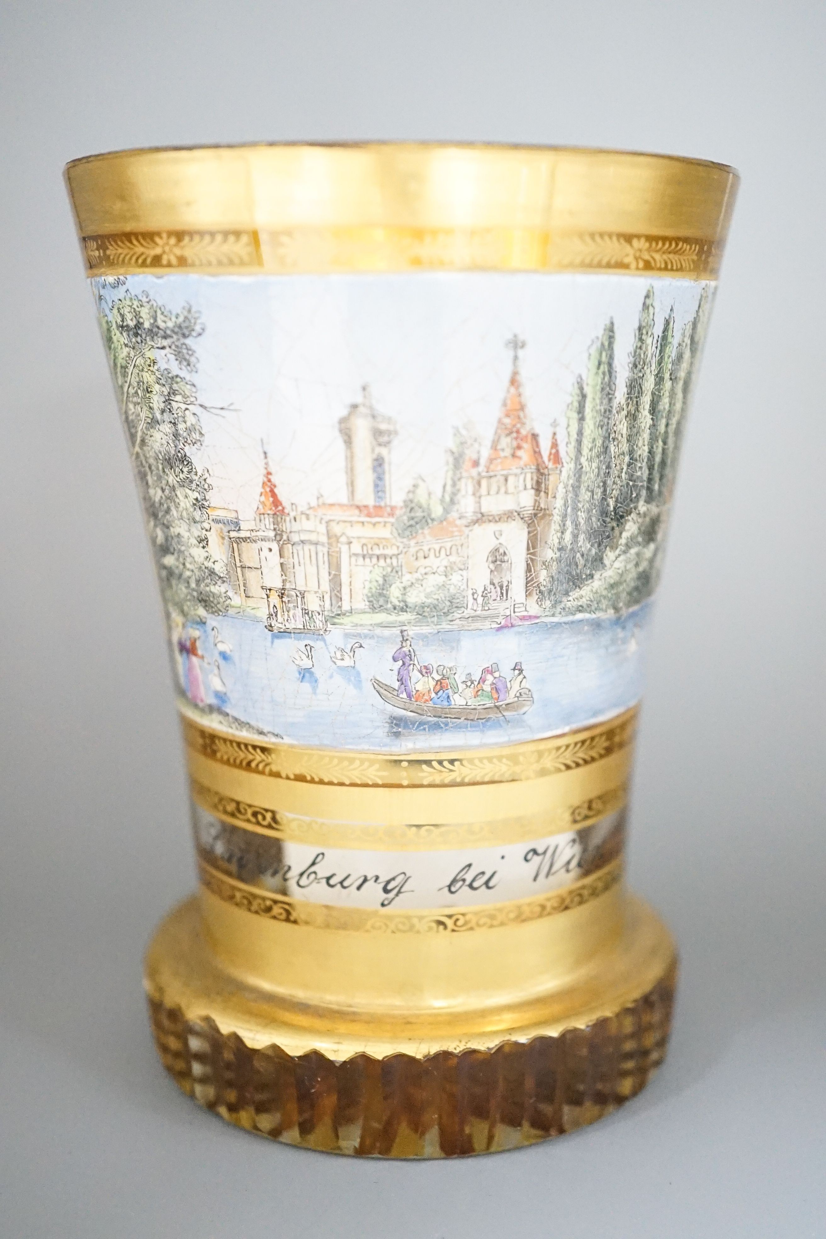 A 19th century Bohemian enamelled and gilded glass beaker 11cm, with titled scene Layenburg bei Wien
